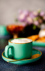 Turquoise coffee cup with milk foam