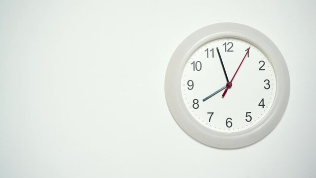 White wall clock ticking showing eight hours. 8 o'clock. Time deadline concept. Timelapse.