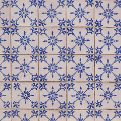 Fragment of building wall with colorful ceramic wall tiles, Azulejo close up. Abstract decorative background, textured ornate pattern for design or backdrop. Traditional ornate Portuguese architecture