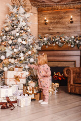 two-year-old girl and Christmas tree