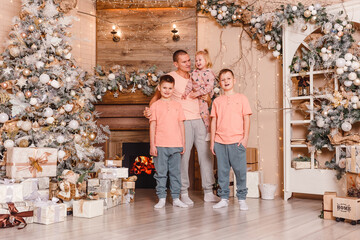 man and three children in beautiful clothes in the Christmas tree