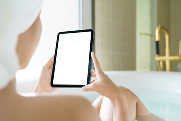 Using digital tablet, Women holding digital tablet while soaking