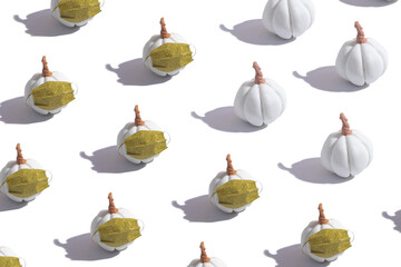 Pattern pumpkin in a medical mask with glitter. Creative Thanksgiving and halloween during coronavirus pandemic