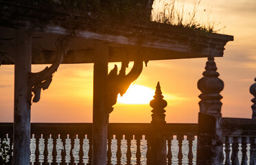 During the sunset, look through the abandoned pavilion in the middle of the sea at Chittaphawan Temple, Chonburi Province, Thailand.