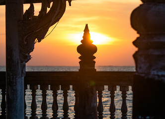 During the sunset, look through the abandoned pavilion in the middle of the sea at Chittaphawan Temple, Chonburi Province, Thailand.
