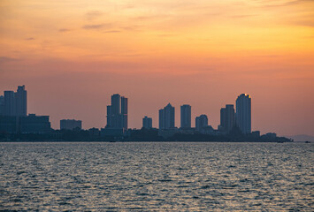 Pattaya city viewed from the middle of the sea during the sunset