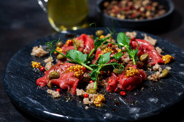 fresh beef carpaccio with capers and arugula