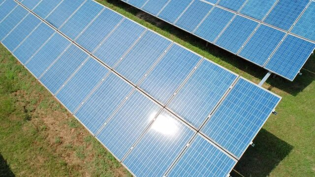 Aerial tilt shot of Solar Panels Farm solar cell. Renewable green alternative energy concept.