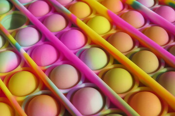 Closeup of Colorful Trendy Pop-it Toy in Pink, Yellow, Orange