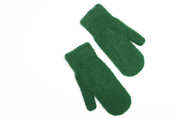 Pair of winter green mittens isolated on white background. Winter clothes. Flat lay, top view.