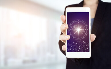 GPS map, pin address location on mobile apps. Hand hold white smartphone with digital hologram sign on light blurred background. Navigation concept. Map and innovation concept