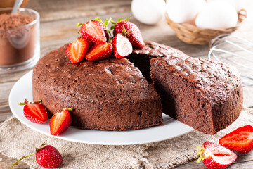 Chocolate sponge cake with strawberry on a table