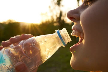 pretty woman drinking water from a bottle summer thirst