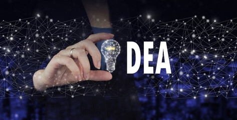 Creative idea.Concept of idea and innovation. Hand hold digital hologram light bulb sign on city dark blurred background. Innovation and creative idea concept.