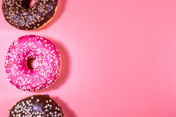 Fresh glazed donuts isolated on a pink background