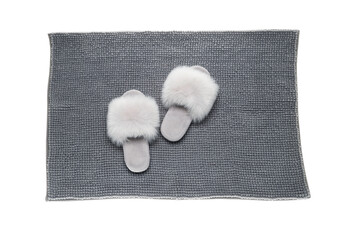 Fototapeta na wymiar Soft grey bath mat and slippers isolated on white, top view