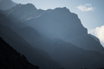 Hazy layered mountain peaks in morning. Landscape of foggy mountain in morning sun ray at Spiti valley, Himachal Pradesh