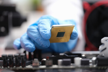 Repairman installing computer processor into motherboard closeup