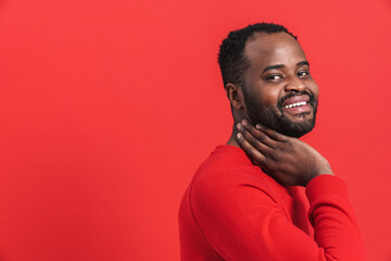 Black bearded man smiling and looking at camera