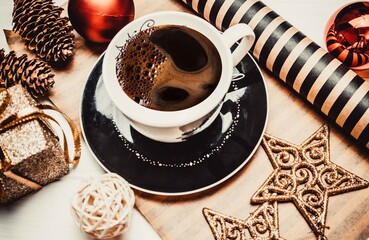 Cup of coffee and christmas decorative on a wooden white background
