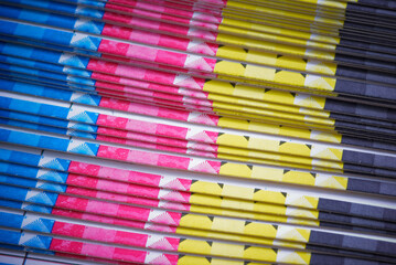 CMYK color bars. Stack of the printing brochures ready to a folding.