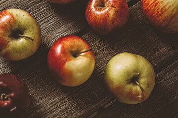 Ripe yellow-red juicy apples on a natural wood table
