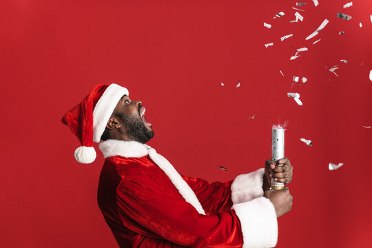 Black Man In Santa Suit Screaming While Blowing Up Party Popper