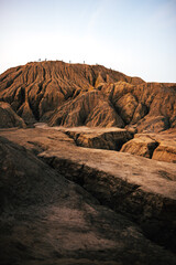 Sandy-clay mountain with slopes washed out by rain. An artificially created quarry. Used for coal mining. Beautiful relief. People go hiking