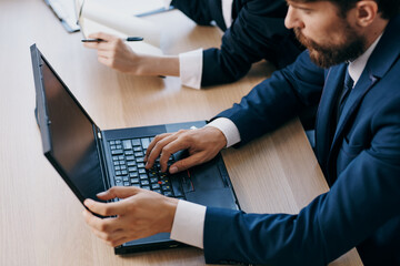 business man and woman in the office in front of a laptop career network technologies