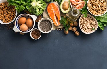 Food sources of omega 3 and healthy fats on dark background top view. Copy Space