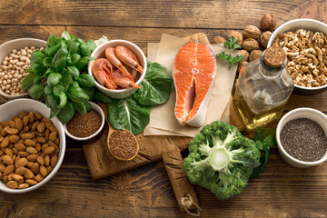 Fototapeta Set of food for healthy nutrition on a wooden background top view. Food sources of omega 3 and omega 6 obraz