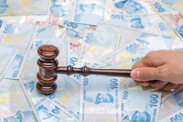 Court gavel on money background. Turkish lira money and judges gavel on table. Judgement and bribe....