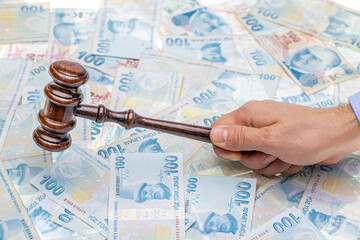 Court gavel on money background. Turkish lira money and judges gavel on table. Judgement and bribe....