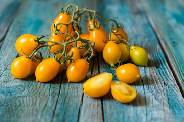 Vesuvius yellow Piennolo or simply Vesuvian Tomato, on blue wooden background. Piennolo is a cluster tomato grown in Naples, Italy.