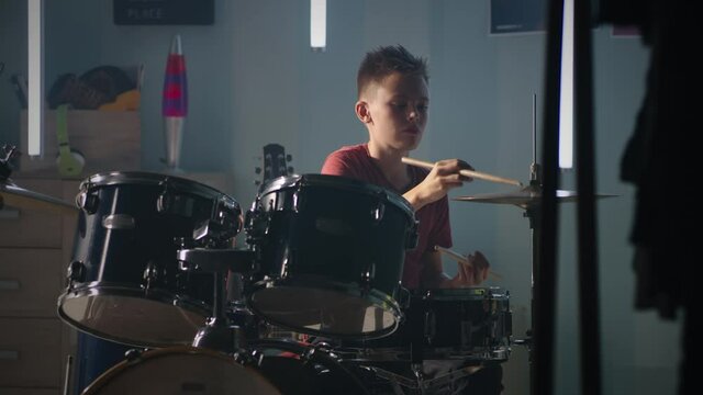 Teen drummer practicing at home