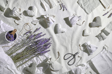 Dry lavender sachets in textile bags and soft hearts. Dry lavender flowers for stuffing, scissors...