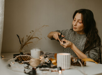 woman making diy garland for Christmas