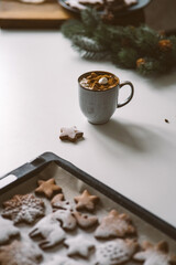 Hot cocoa with marshmallows in a Christmas atmosphere with gingerbread