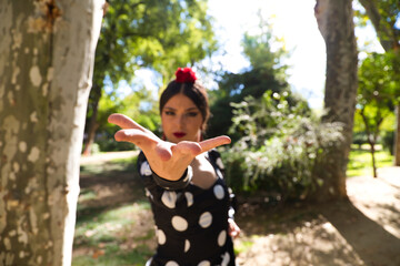 Spanish, beautiful, brunette flamenco dancer woman in typical flamenco dress with white polka dots...