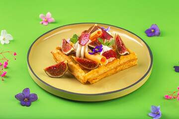 Belgian waffles with cream figs flowers and berries