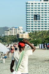 Man selling typical food on Bello Horizonte beach. Santa marta, Magdalena, Colombia.