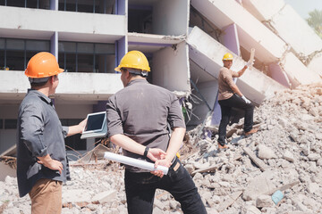 Demolition control supervisor and contractor discussing on demolish building.