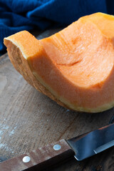 Piece of pumpkin on rustic background