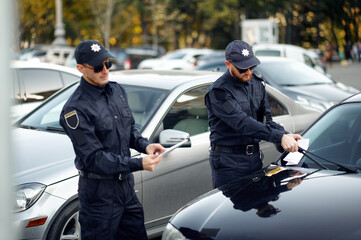Police officers issue a ticket in the parking lot