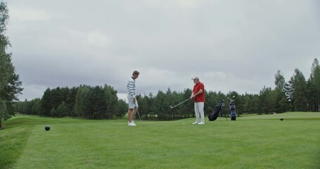 Teaching to play golf on a spacious lawn with modern equipment