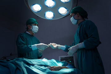 Asian Surgical Team Performing Surgery in Operating Room