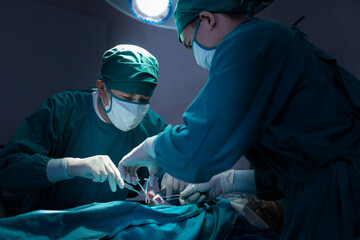 Asian Surgical Team Performing Surgery in Operating Room