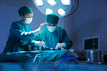 Asian Surgical Team Performing Surgery in Operating Room