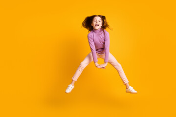 Fototapeta na wymiar Full length body size view of attractive funny girlish cheerful girl jumping having fun fooling isolated over bright yellow color background