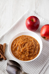 Homemade Raw Apple Sauce in a White Bowl, side view.